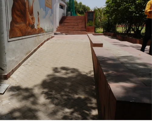Wheelchair user navigating a concrete building ramp